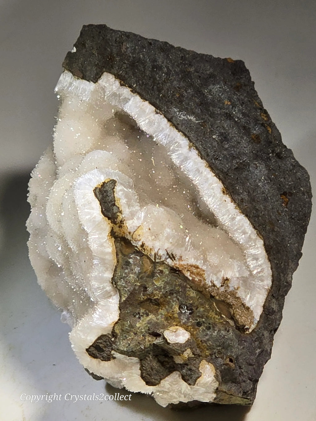 Quartz crystal cluster with dark matrix, showcasing natural mineral formation and geode-like structure