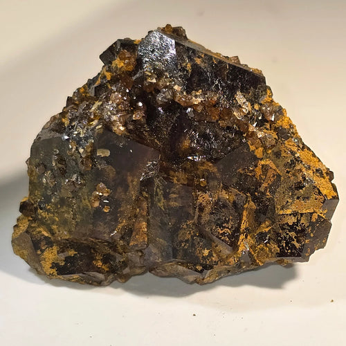 Fluorite crystal specimen with metallic luster and golden matrix, ideal for mineral collectors