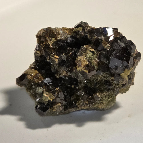 Magnetite crystal specimen with metallic luster on matrix, ideal for mineral collectors and geological study