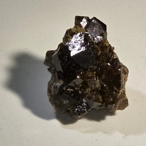 Fluorite crystal specimen with metallic luster, dark cubic formations on matrix, mineral collector's item