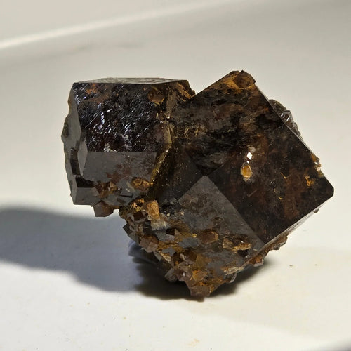 Fluorite crystal specimen with cubic formation and earthy matrix, showcasing natural mineral texture and luster