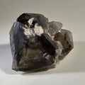 Fluorite crystal specimen with white inclusions, showcasing natural mineral formation and geometric facets.