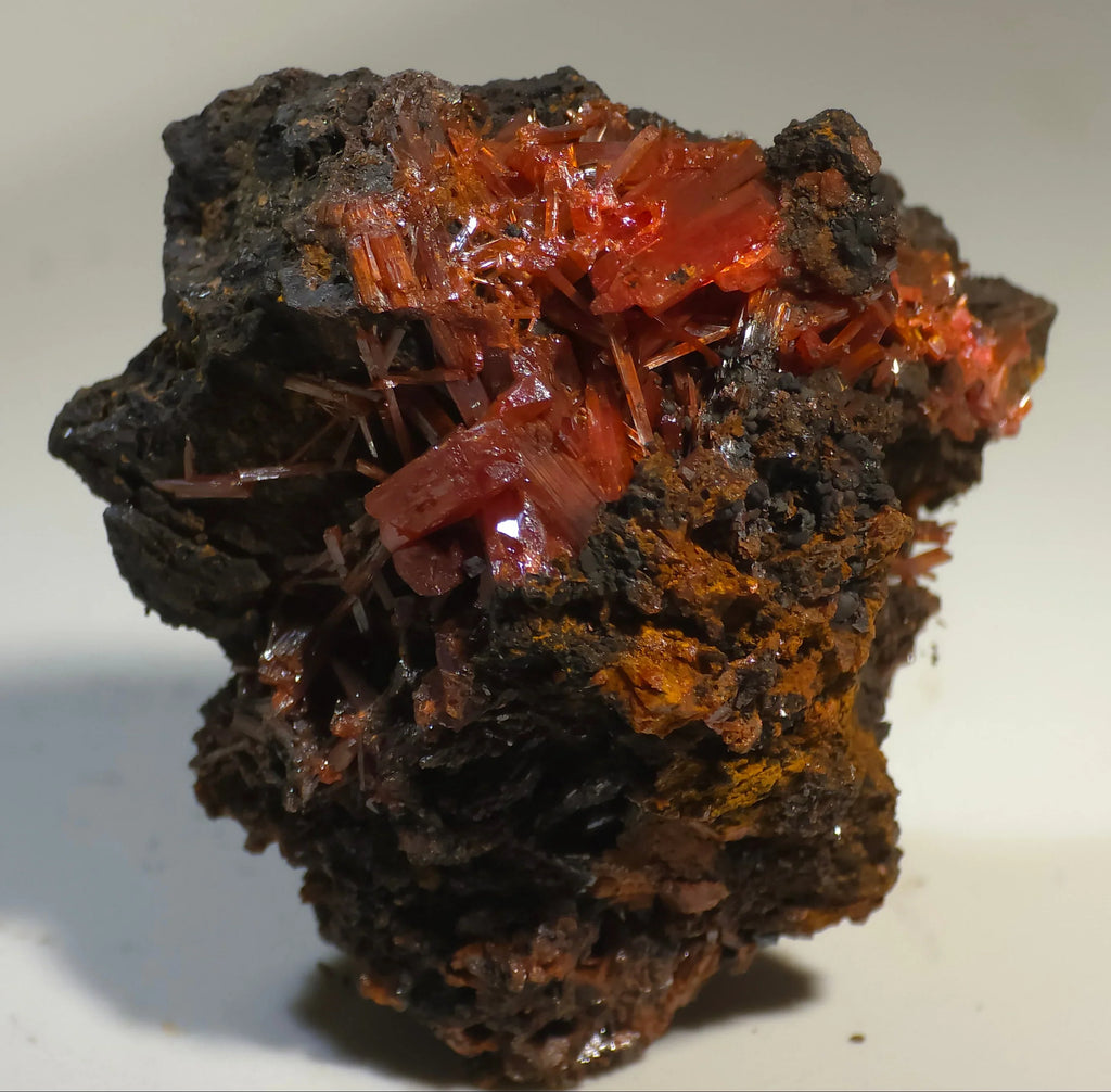 Crocoidite mineral specimen with vibrant red crystals on dark matrix, classic locality specimen for collectors