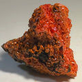 Vibrant red-orange Crocoite mineral specimen with sharp crystalline texture, ideal for collectors and geology enthusiasts.