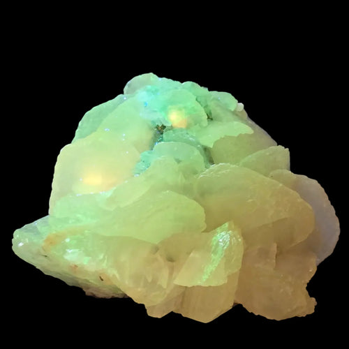 Fluorite mineral specimen with vibrant green to yellow fluorescence, glowing under UV light