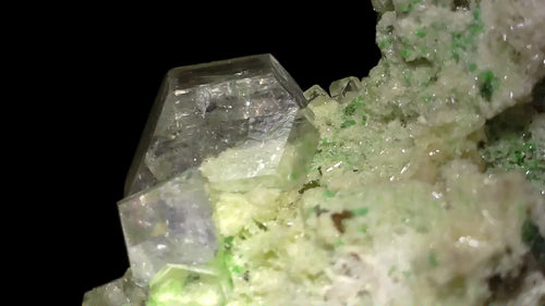 Fluorite crystal with green inclusions, clear cubic formation on matrix