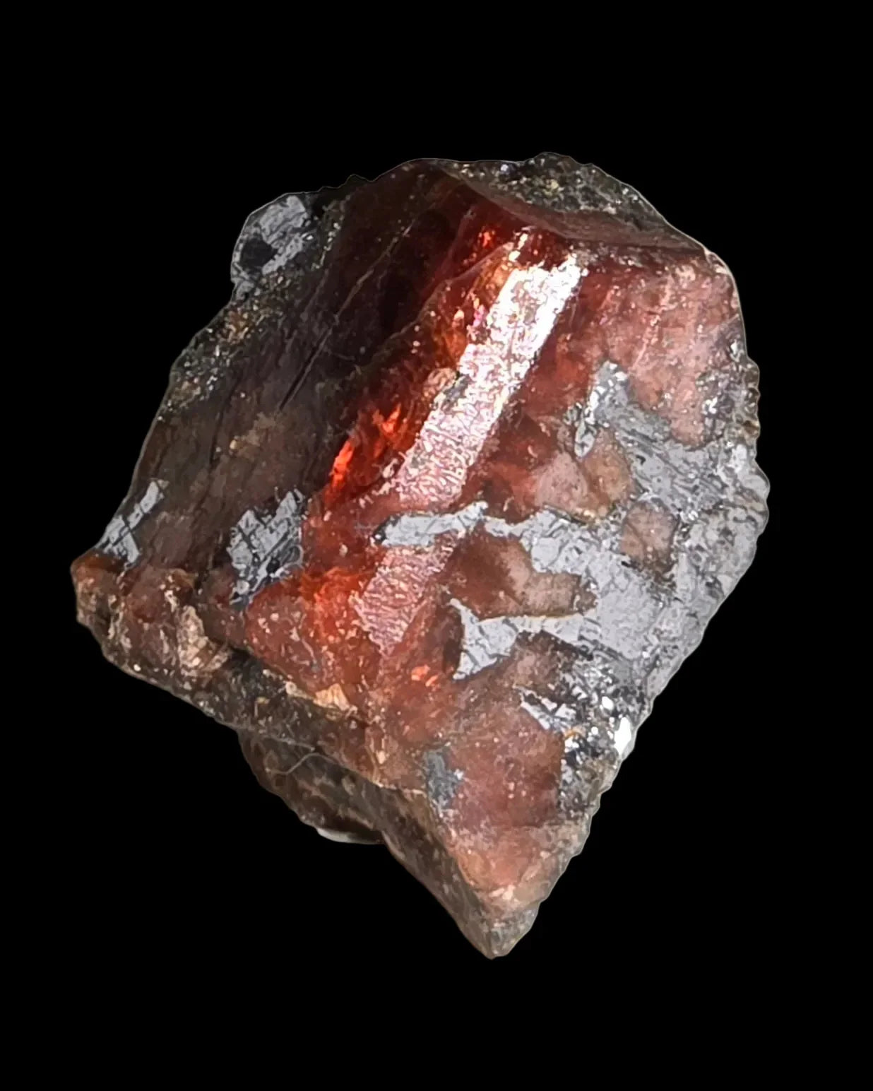 Spessartine Garnet crystal from Namibia, showcasing deep red hues and metallic luster against dark matrix