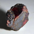 Almandine Garnet crystal with deep red interior and dark matrix, natural mineral specimen