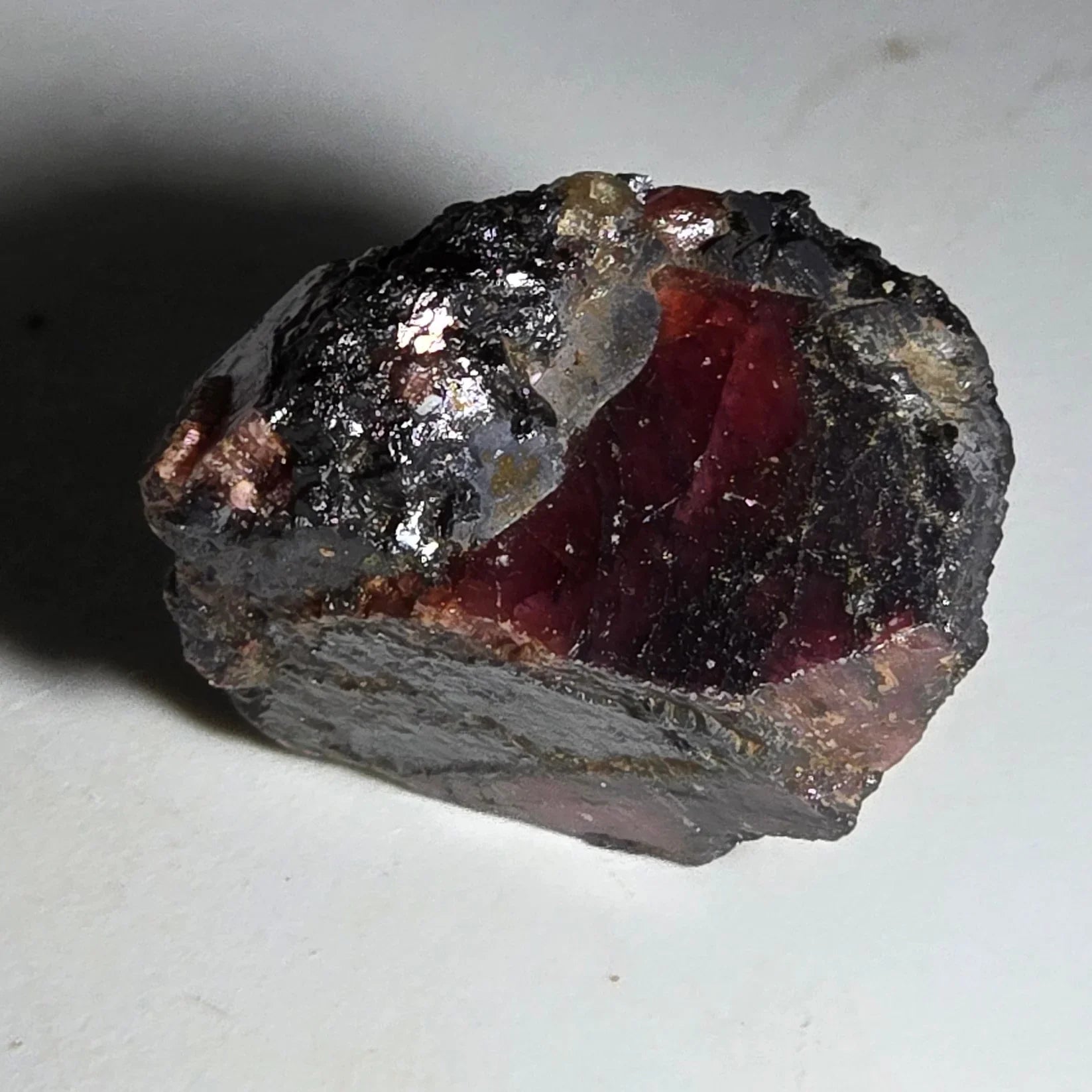 Pyrope Garnet crystal with deep red core and dark matrix, natural mineral specimen