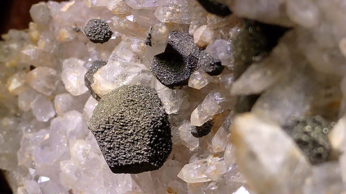 Hematite on Quartz crystal specimen, textured metallic spheres on clear mineral matrix
