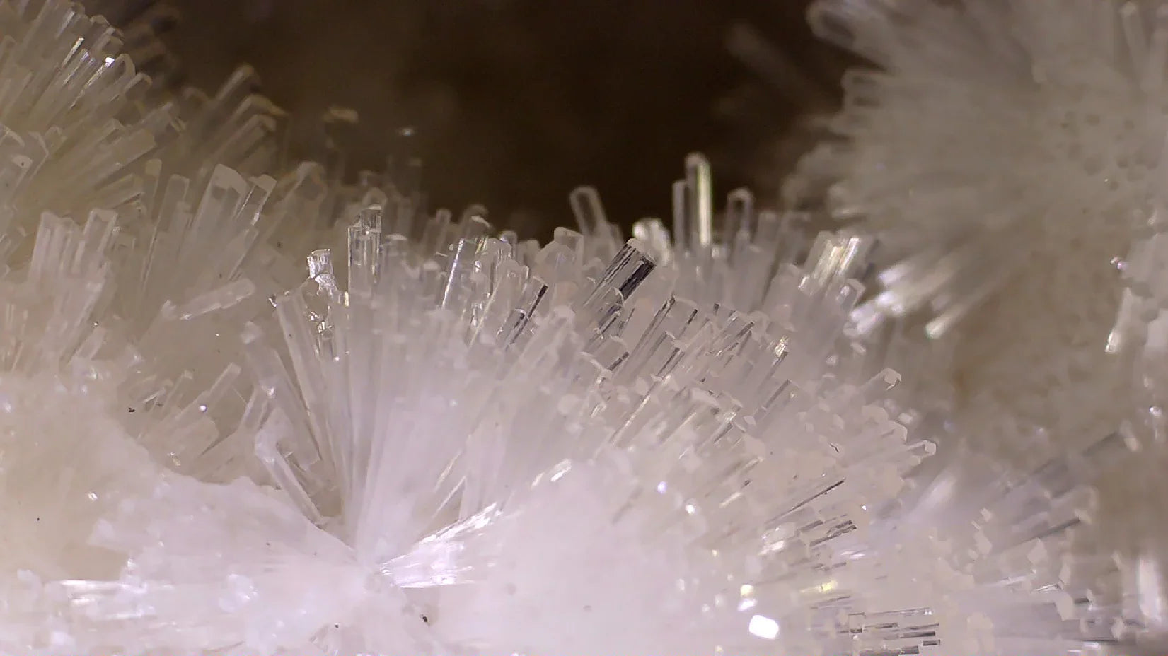 Clear quartz crystal cluster with needle-like formations, natural mineral specimen