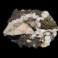 Calcite on basalt matrix, white crystalline formations with earthy tones, mineral specimen for collectors