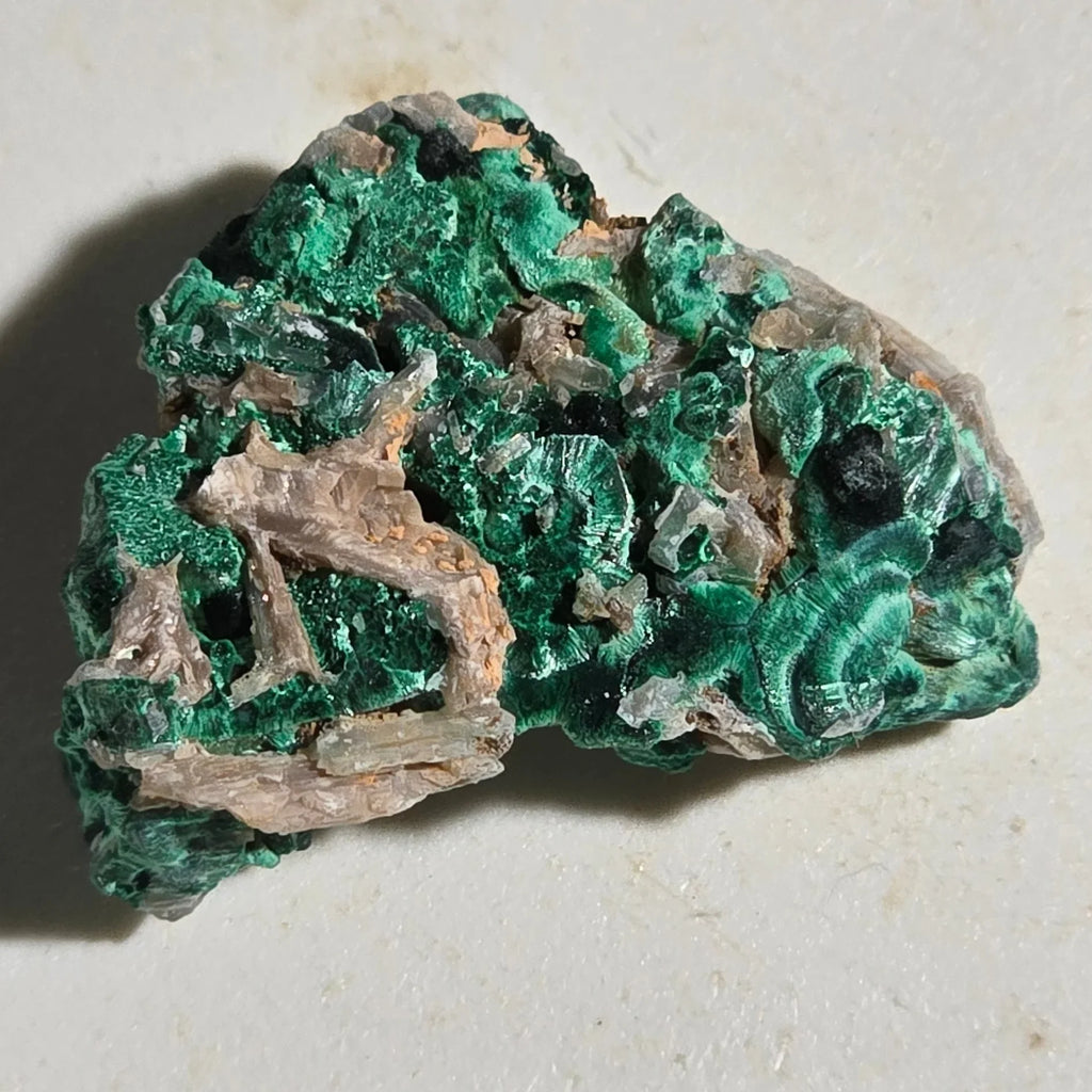 Malachite mineral specimen with vibrant green botryoidal formations on matrix, natural crystal cluster