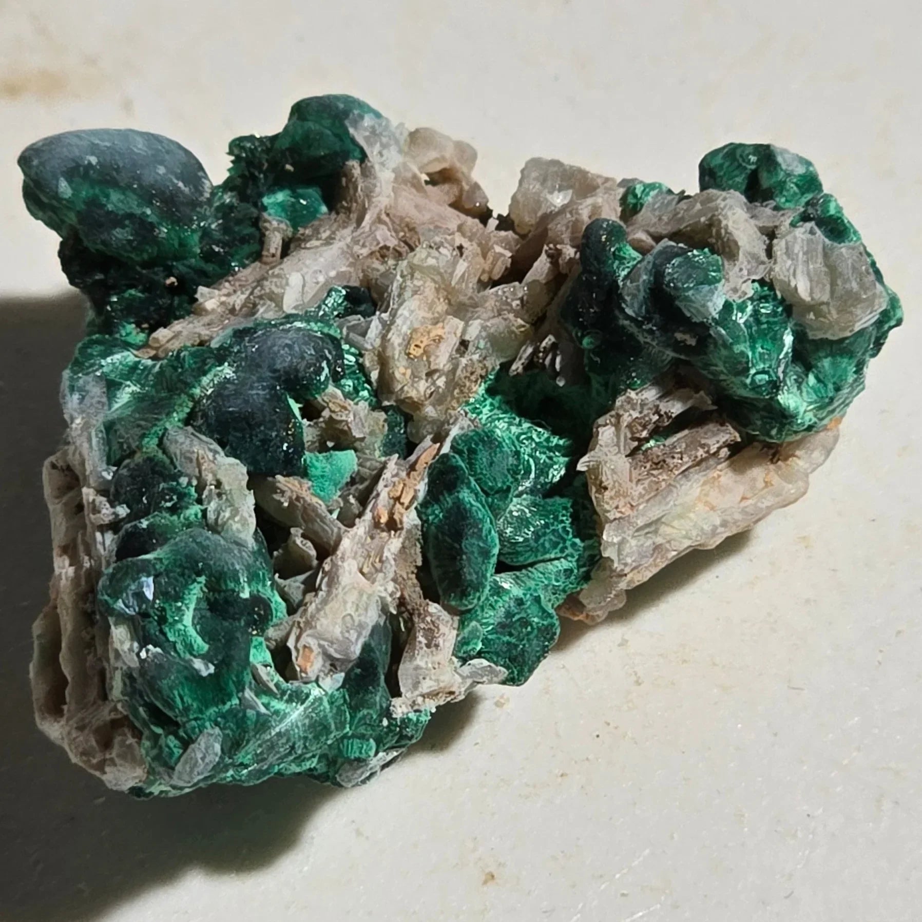 Malachite mineral specimen with vibrant green botryoidal formations on matrix, natural crystal cluster