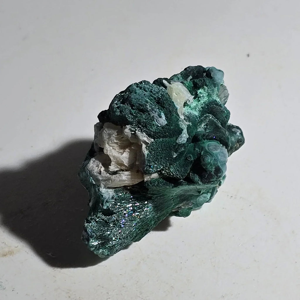 Malachite mineral specimen with vibrant green crystals and white matrix, natural geological formation