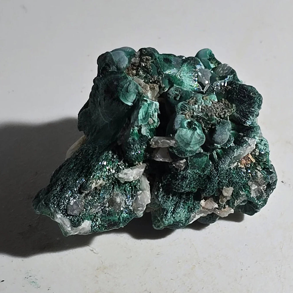 Malachite mineral specimen with vibrant green botryoidal formations and quartz crystals