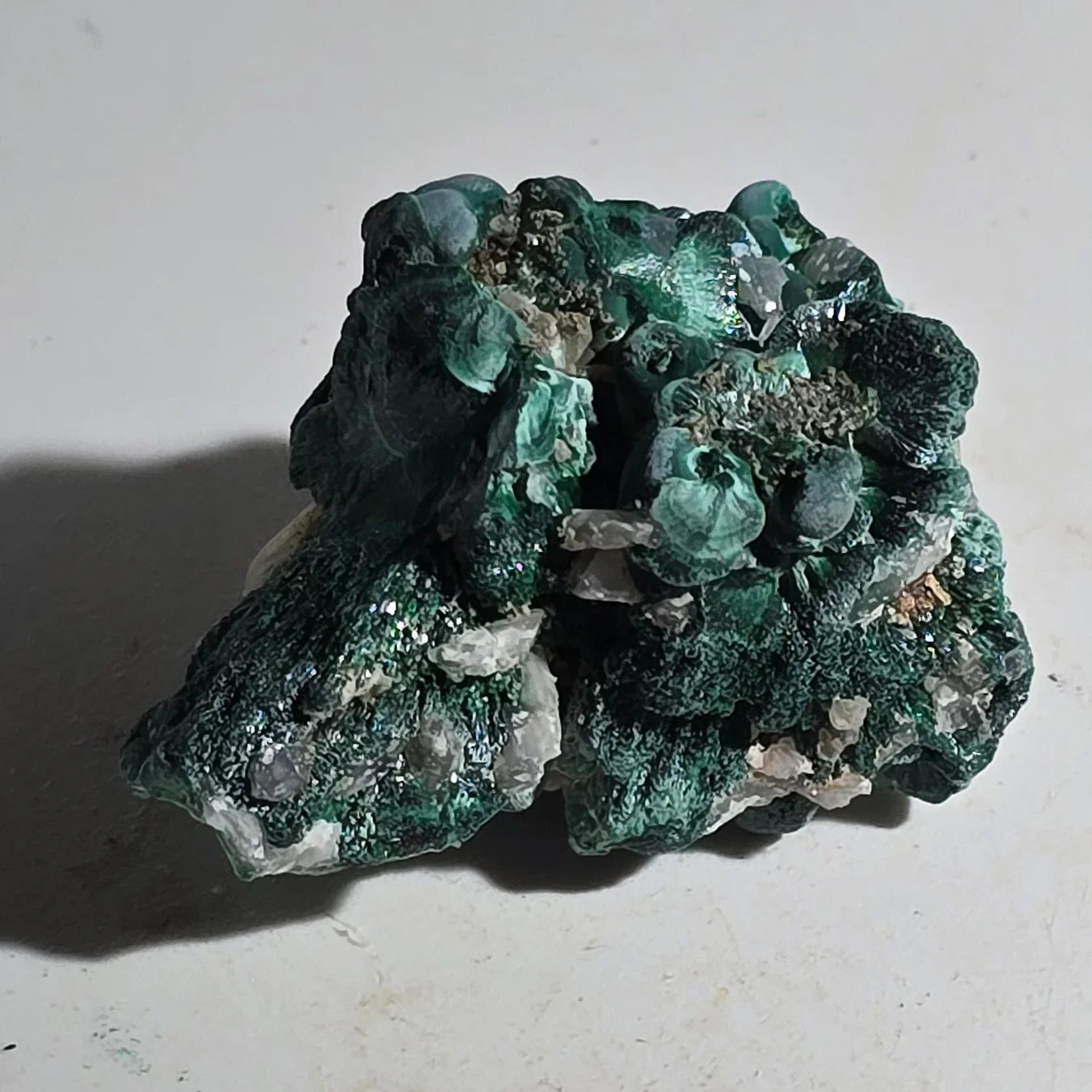 Malachite mineral specimen with vibrant green botryoidal formations and quartz crystals