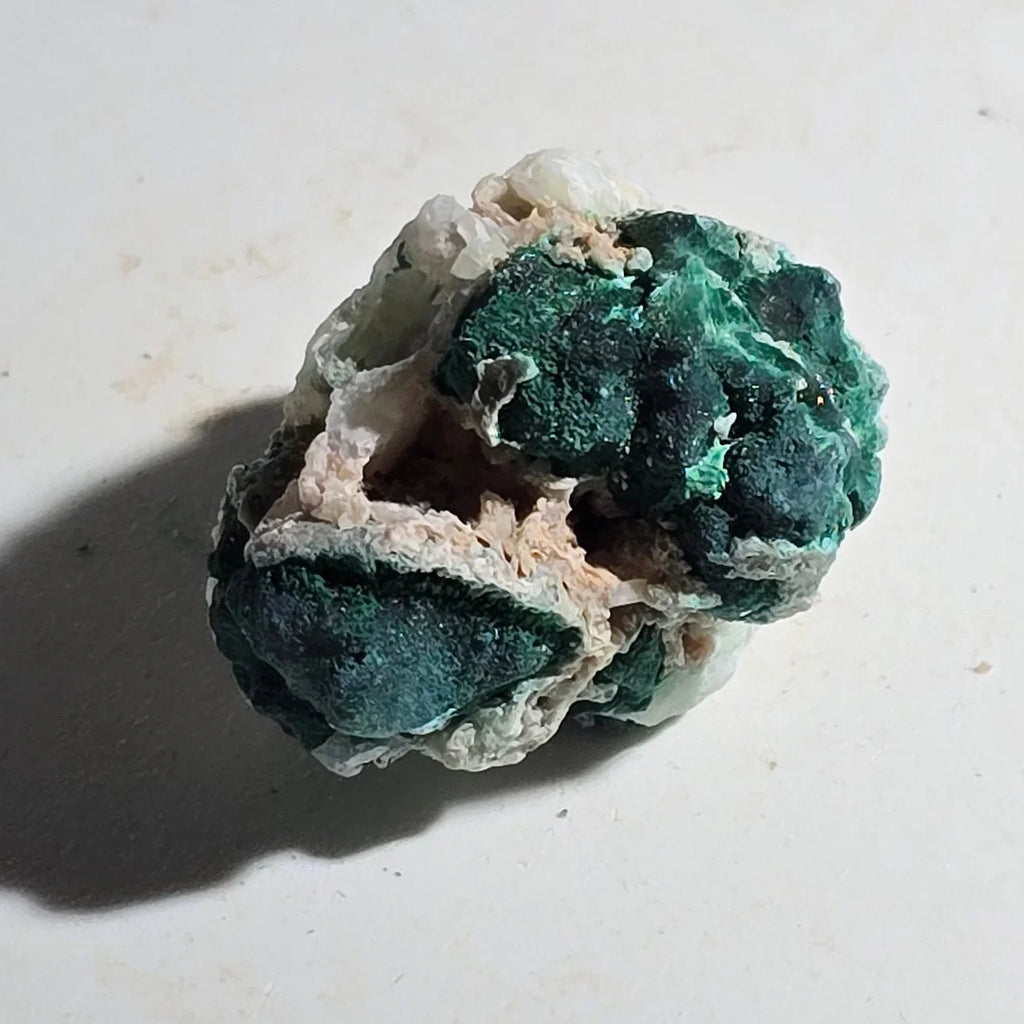 Malachite on Chalcedony specimen, vibrant green mineral clusters on white matrix, collector-grade crystal