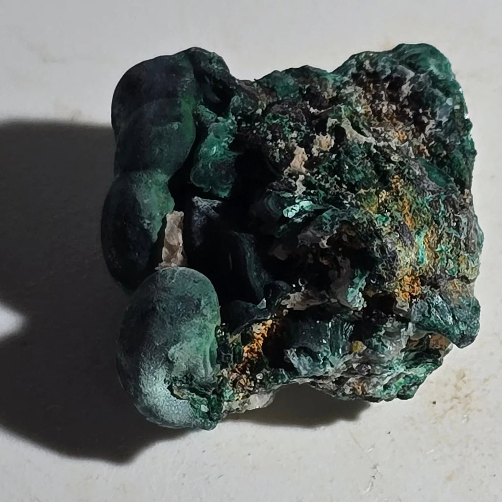 Malachite mineral specimen with vibrant green botryoidal formations, natural crystal texture