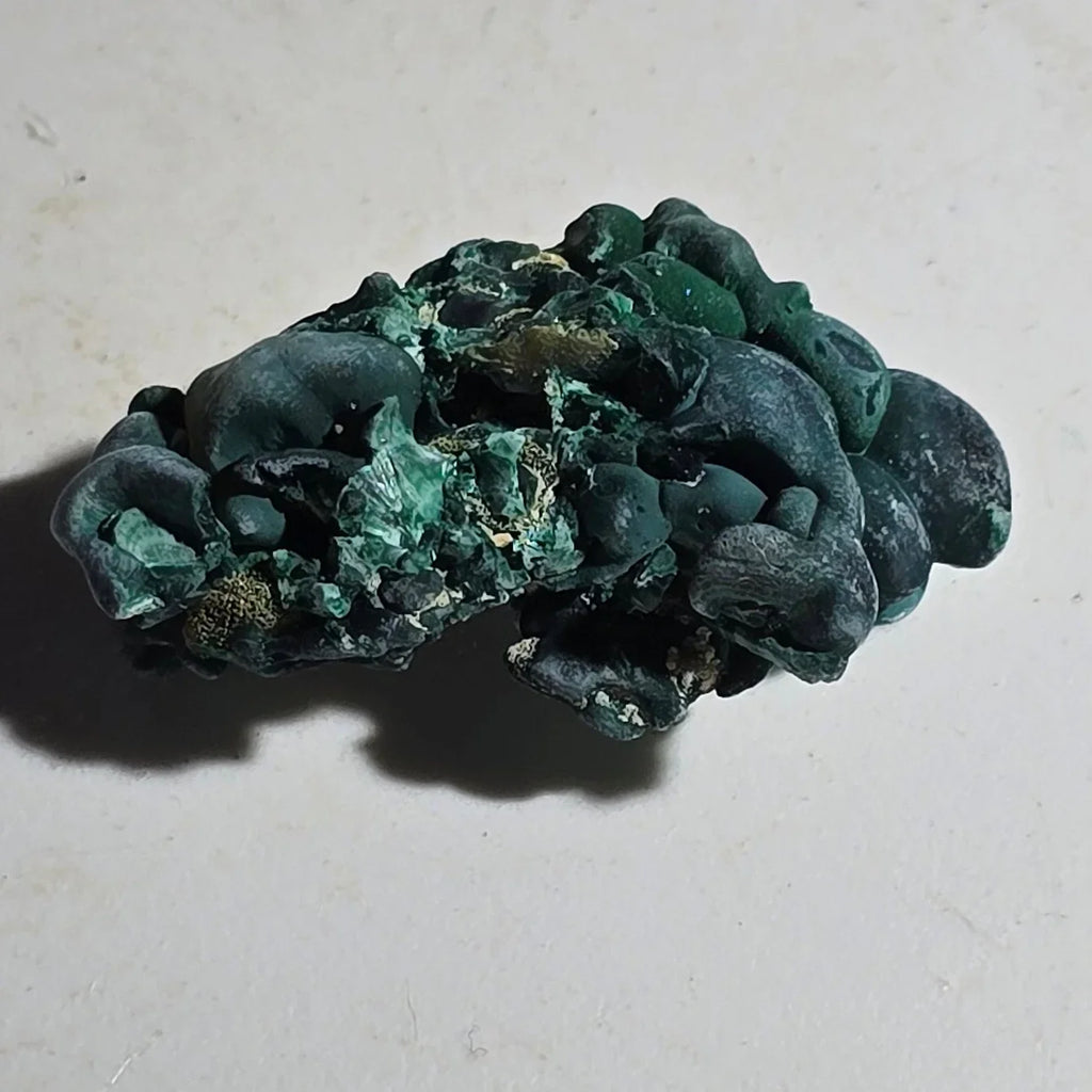 Malachite mineral specimen with botryoidal texture, vibrant green color, and earthy matrix