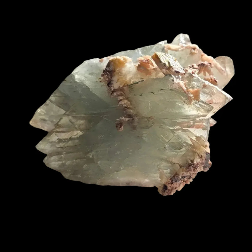 Fluorite crystal specimen with pink and brown matrix, showcasing natural mineral formation