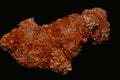 Vibrant orange crystal cluster with sparkling facets, showcasing natural mineral beauty