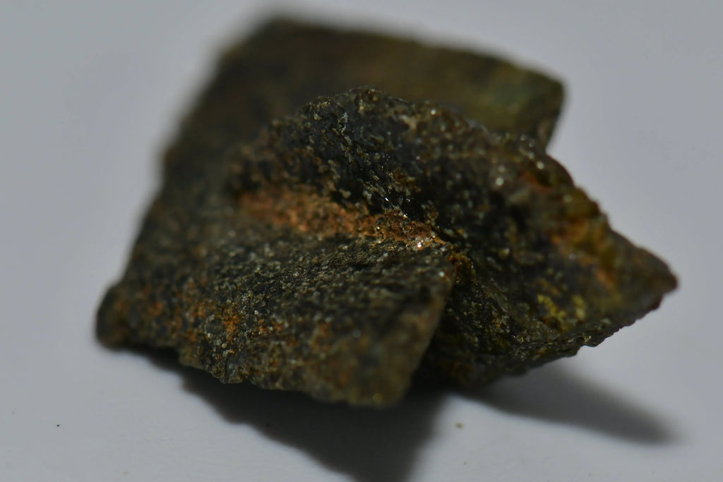 Chalcopyrite mineral specimen with metallic luster and greenish-gold hues, natural crystal formation