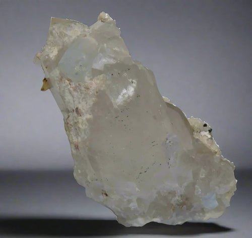Quartz crystal specimen from classic locality, translucent with natural matrix, mineral collector display