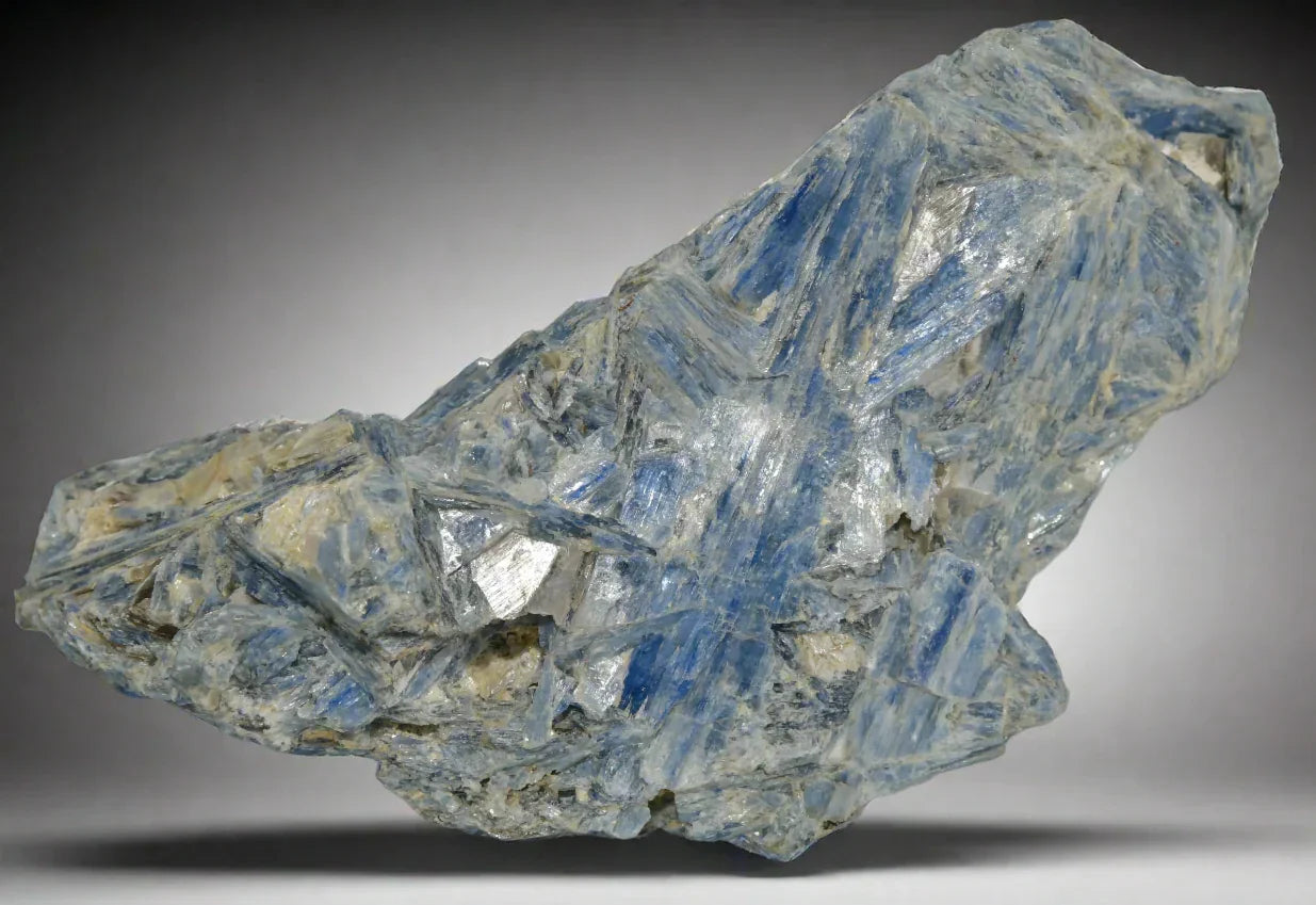 Kyanite crystal specimen with blue striations and metallic inclusions, classic mineral collectible