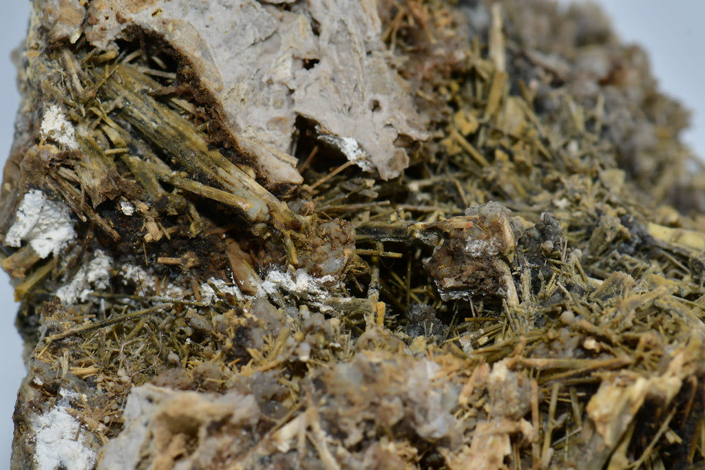 Gypsum crystals with fibrous texture and white matrix, showcasing natural mineral formation details