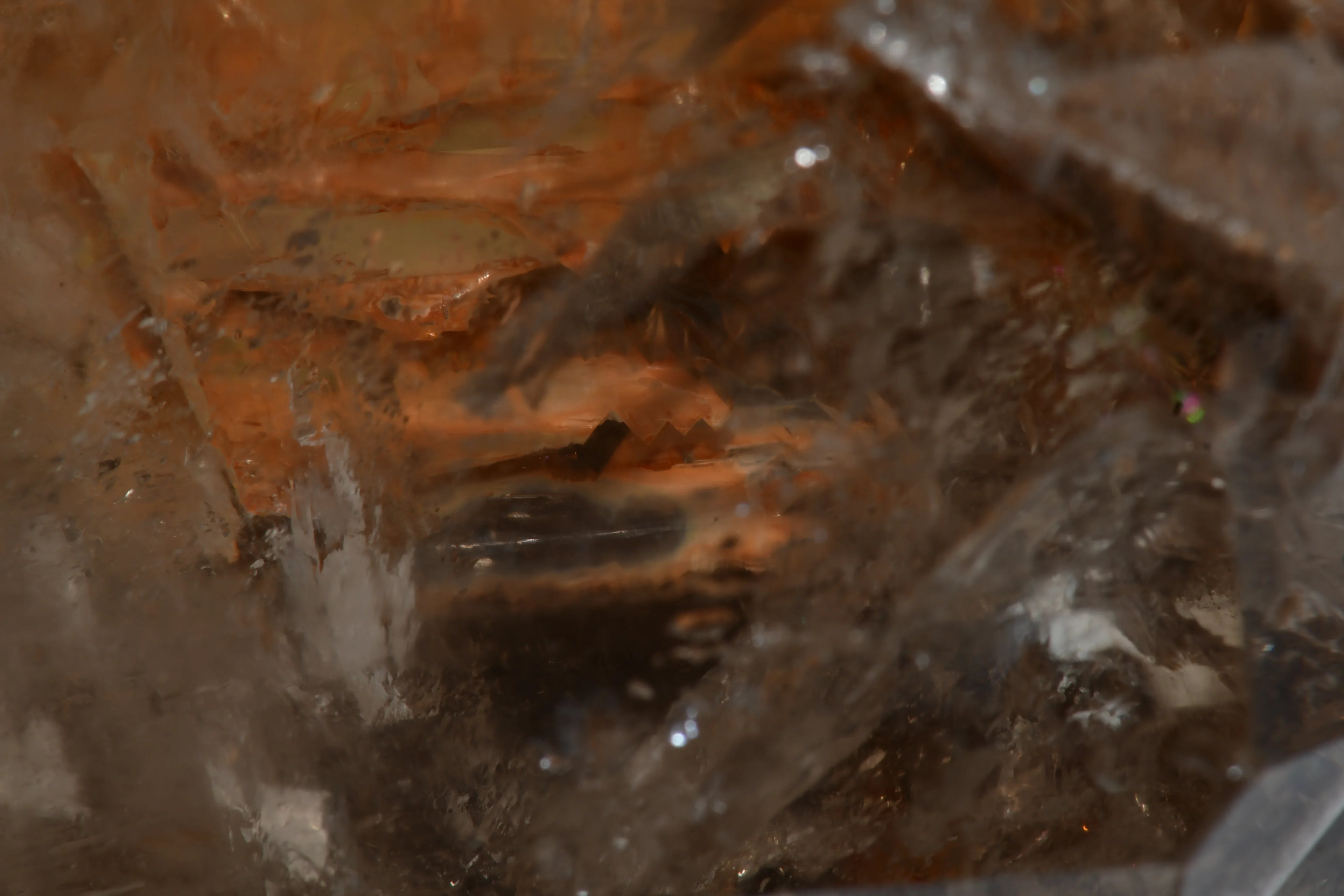 Clear quartz crystal with iron oxide inclusions, showcasing natural mineral formations