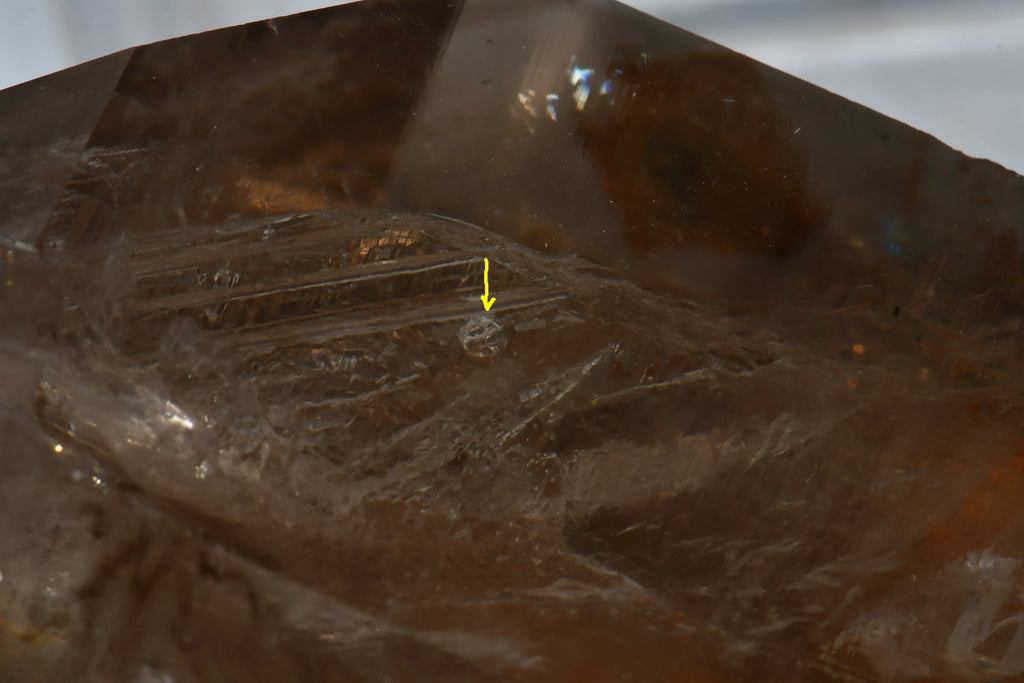 Smoky Quartz with visible growth lines and inclusion, showcasing natural crystal texture and clarity.