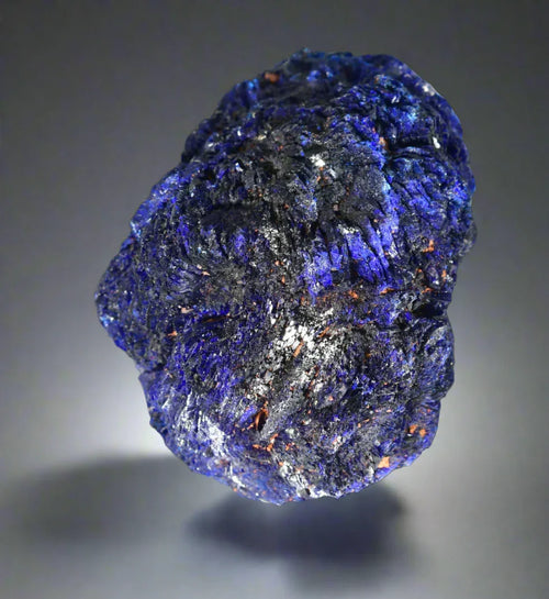 Azurite mineral specimen with deep blue crystals and earthy matrix, showcasing natural geological texture