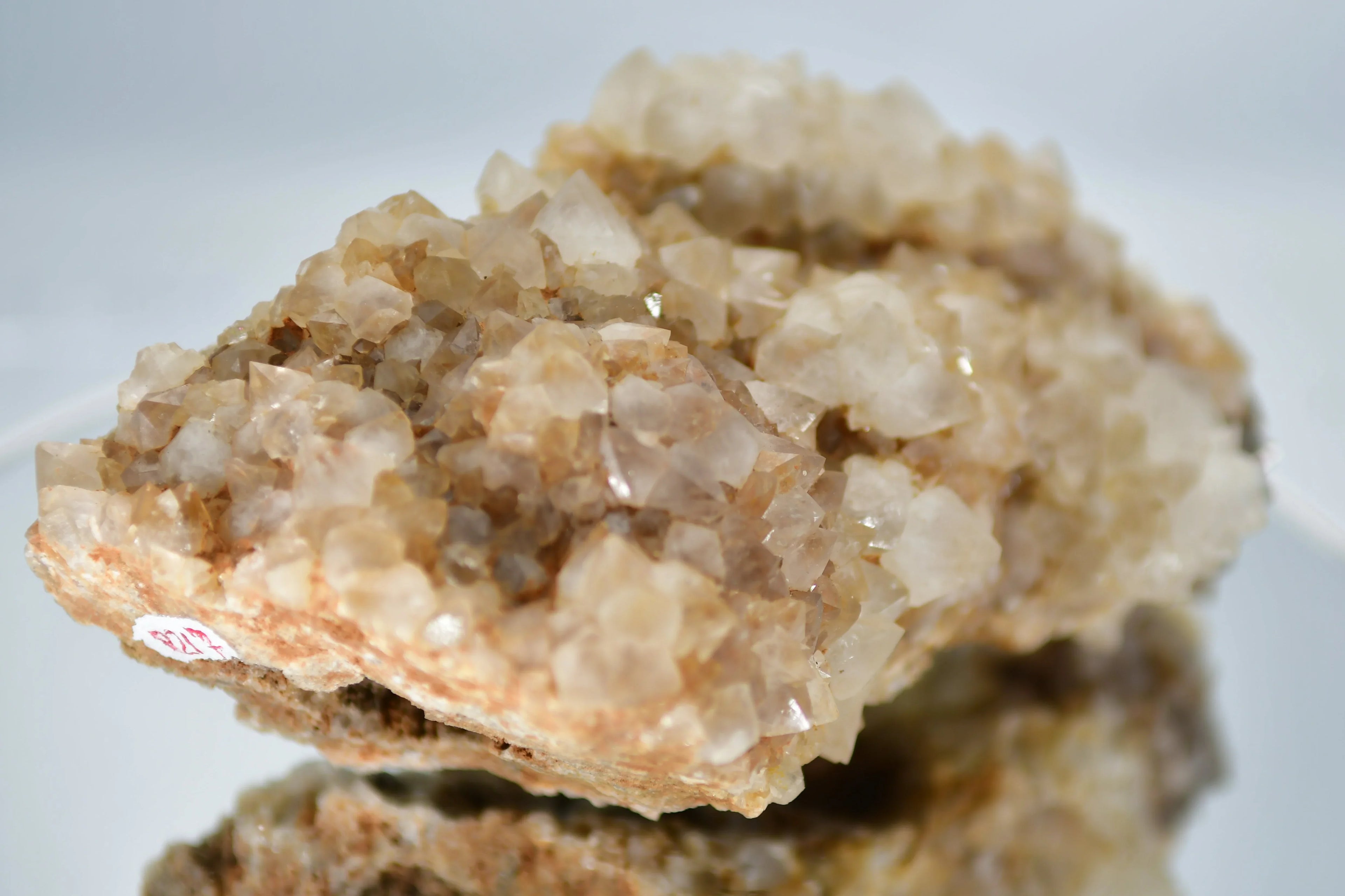 Quartz crystal cluster from Brazil, showcasing natural mineral formations with earthy tones.