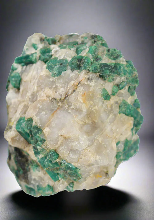 Emerald in matrix from Colombia, vibrant green crystals on white host rock, mineral specimen for collectors